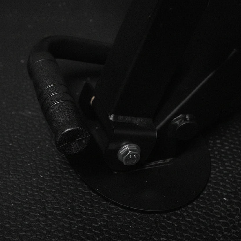 Close-up of a black metal bracket on a dark textured surface