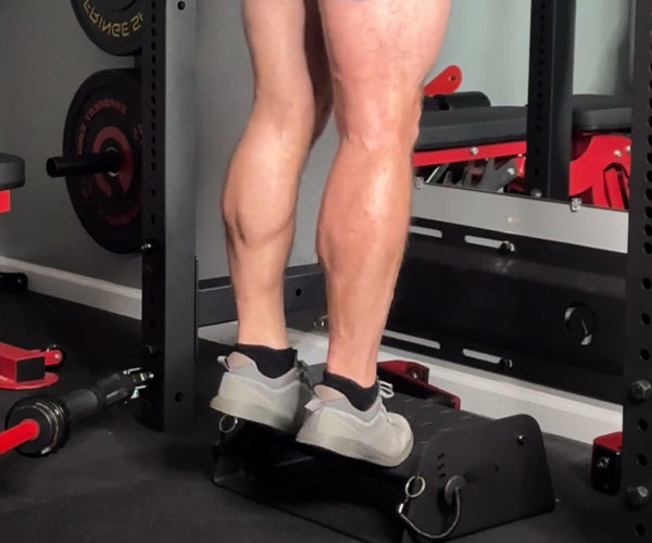Man performing calf raises with the Flex Wedge and Calf Cups from Exponent Edge