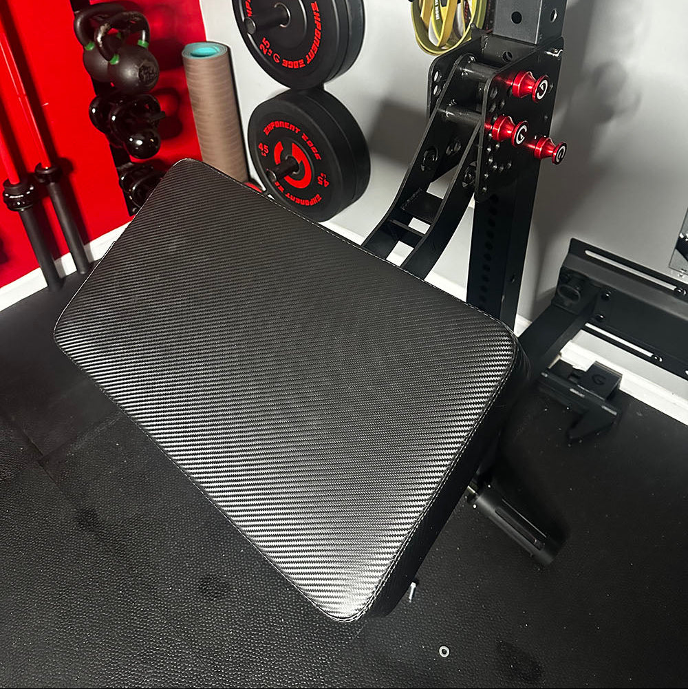 The rack-attaching, Infinity Arm can be utilized for chest-supported, arm-supported, back-supported, head-supported, and many other supported exercises. This image presents the Infinity Large Pad Attachment attached to a power rack from a front view.