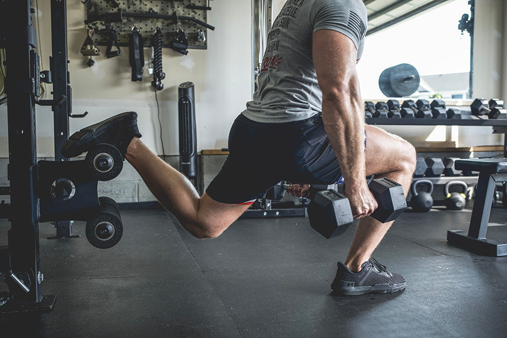 This Rack Mounted Glute Ham Developer is less bulky and lower priced than conventional GHDs. Perfect for glute workouts, ab workouts, and hamstring workouts. This image presents the Rack Mounted Glute Ham Developer being used for a one-legged squat workout.