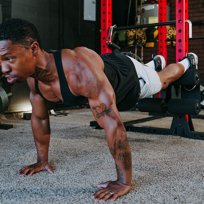 This Rack Mounted Glute Ham Developer is less bulky and lower priced than conventional GHDs. Perfect for glute workouts, ab workouts, and hamstring workouts. This image presents the Rack Mounted Glute Ham Developer being used for a chest workout.