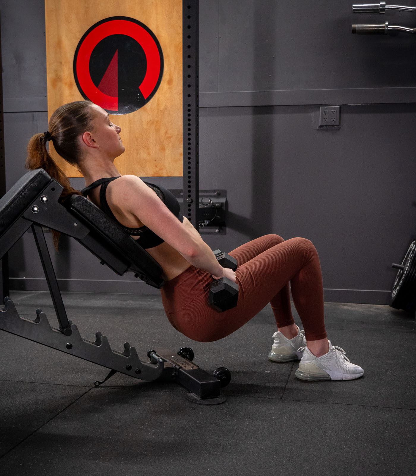 Man performing hip thrusts with the Infinity Bench configured as a half bench