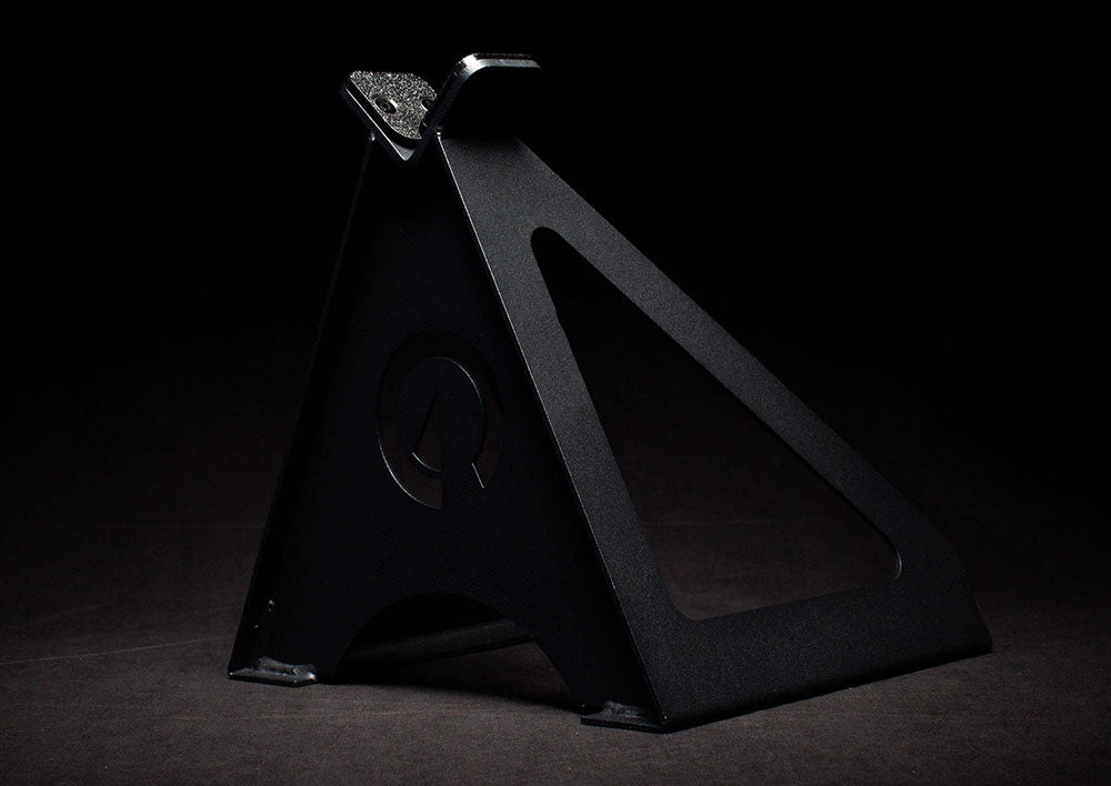 The Edge Landmine Jack is a compact landmine stand that takes the pain out of loading, reloading, and unloading heavy plates onto a barbell while using a landmine. This image presents the Edge Landmine Jack from a side angle.