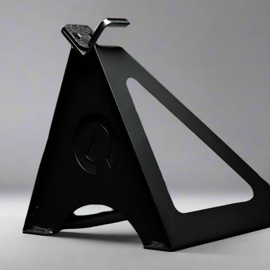 The Edge Landmine Jack is a compact landmine stand that takes the pain out of loading, reloading, and unloading heavy plates onto a barbell while using a landmine. This image presents the Edge Landmine Jack from a side angle.