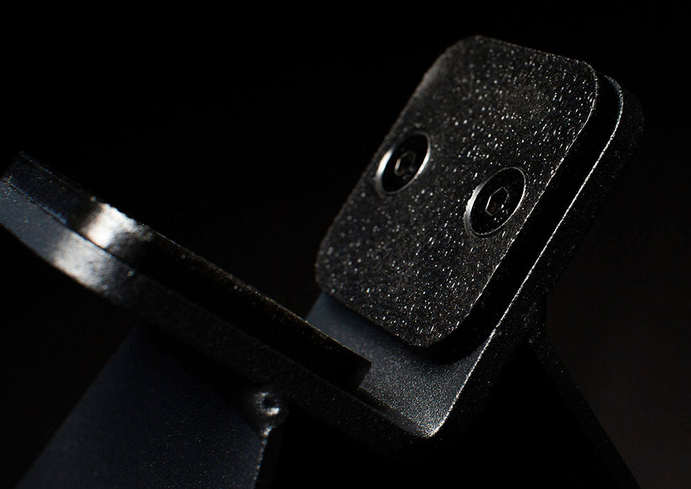 The Edge Landmine Jack is a compact landmine stand that takes the pain out of loading, reloading, and unloading heavy plates onto a barbell while using a landmine. This image presents a close-up of the Edge Landmine Jack.
