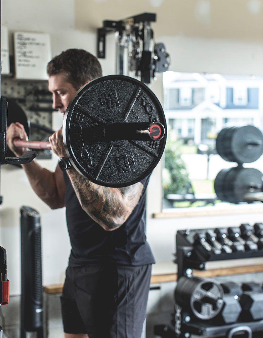 The Edge Bar is a mix between a shortened cambered bar and an EZ Bar. Perfect for enhanced bicep workouts, chest workouts, and more. This image presents the Edge Rackable Cambered Bar being used for a bicep workout.
