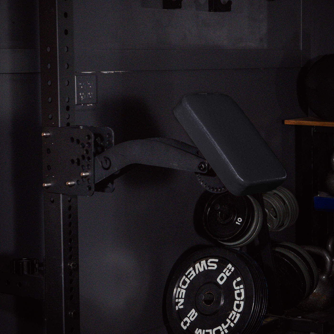 The Infinity Arm being stored on a squat rack, taking up minimal space