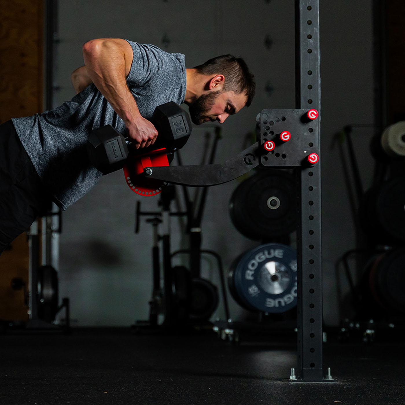 Man using the Infinity Arm with dumbbells in a rowing motion