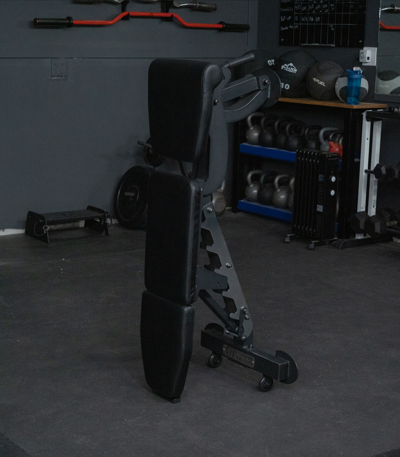 Infinity bench folded and put in a vertical storage position that takes up minimal space in a home and garage gym