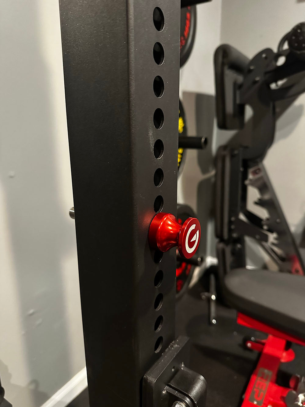 Custom Exponent Edge Magnetic pins fit all major brands of squat racks, power racks, and accessories, including Exponent Edge workout equipment. This image presents the Magnetic Edge Pin from a side view on a power rack.