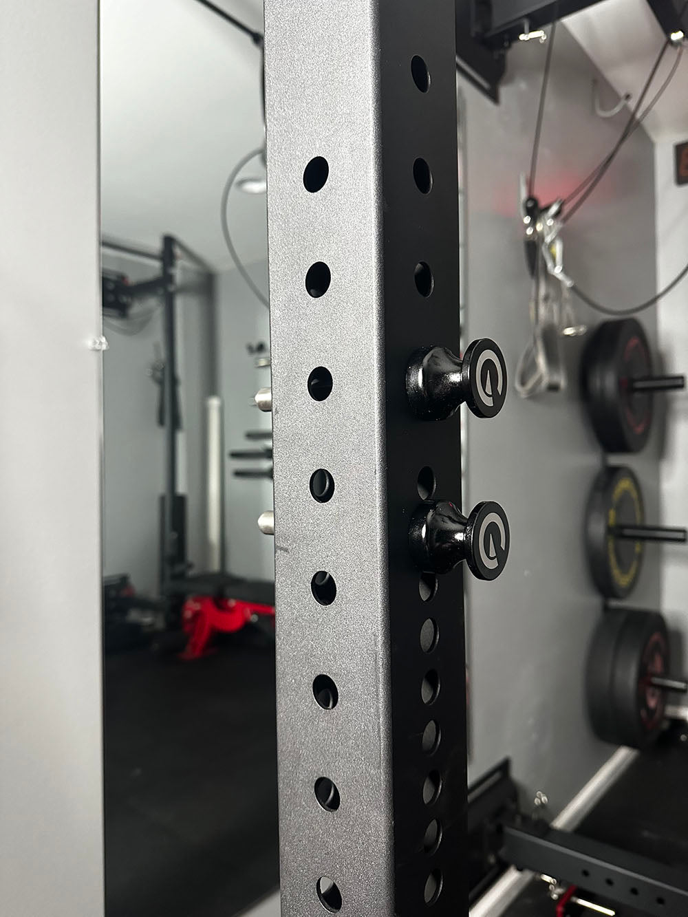 Custom Exponent Edge Magnetic pins fit all major brands of squat racks, power racks, and accessories, including Exponent Edge workout equipment. This image presents the Magnetic Edge Pins in black on a squat rack from a side view.