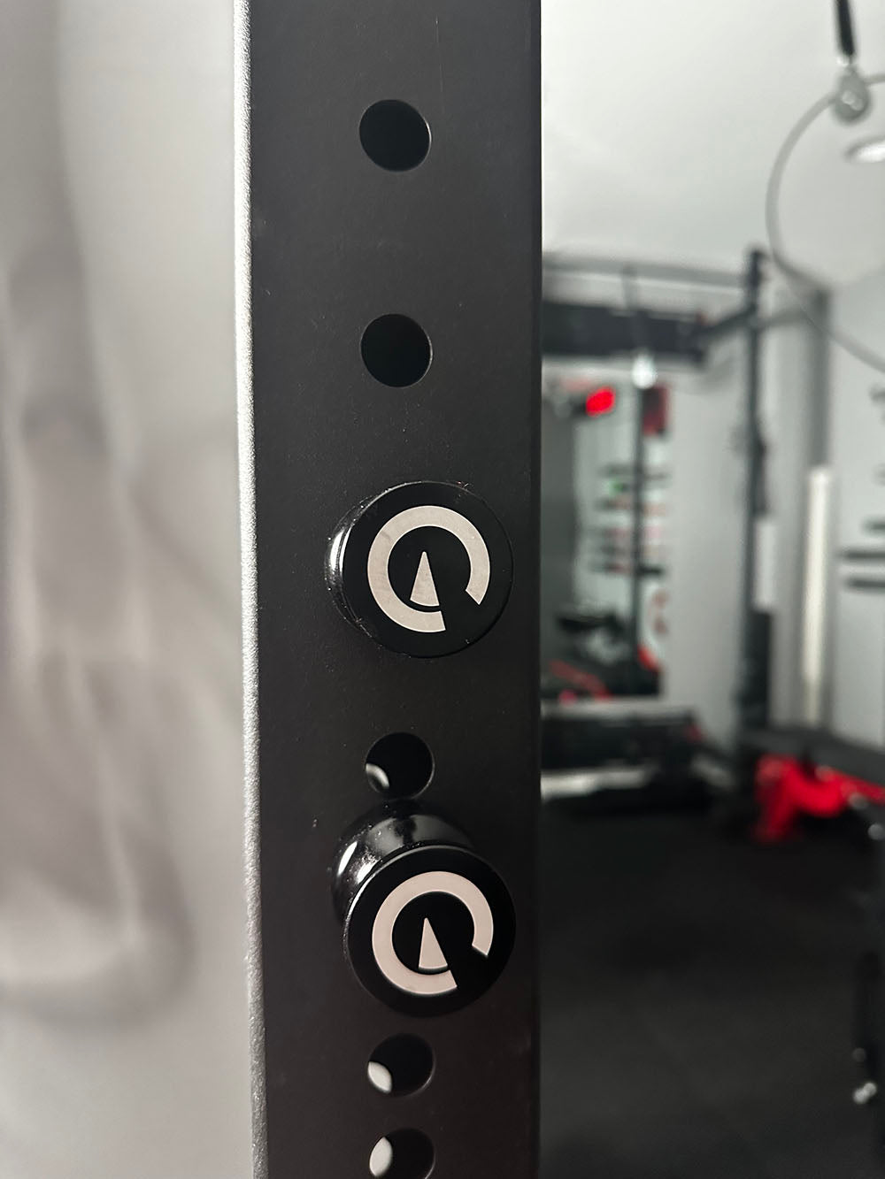 Custom Exponent Edge Magnetic pins fit all major brands of squat racks, power racks, and accessories, including Exponent Edge workout equipment. This image presents the Magnetic Edge Pins in black on a squat rack.
