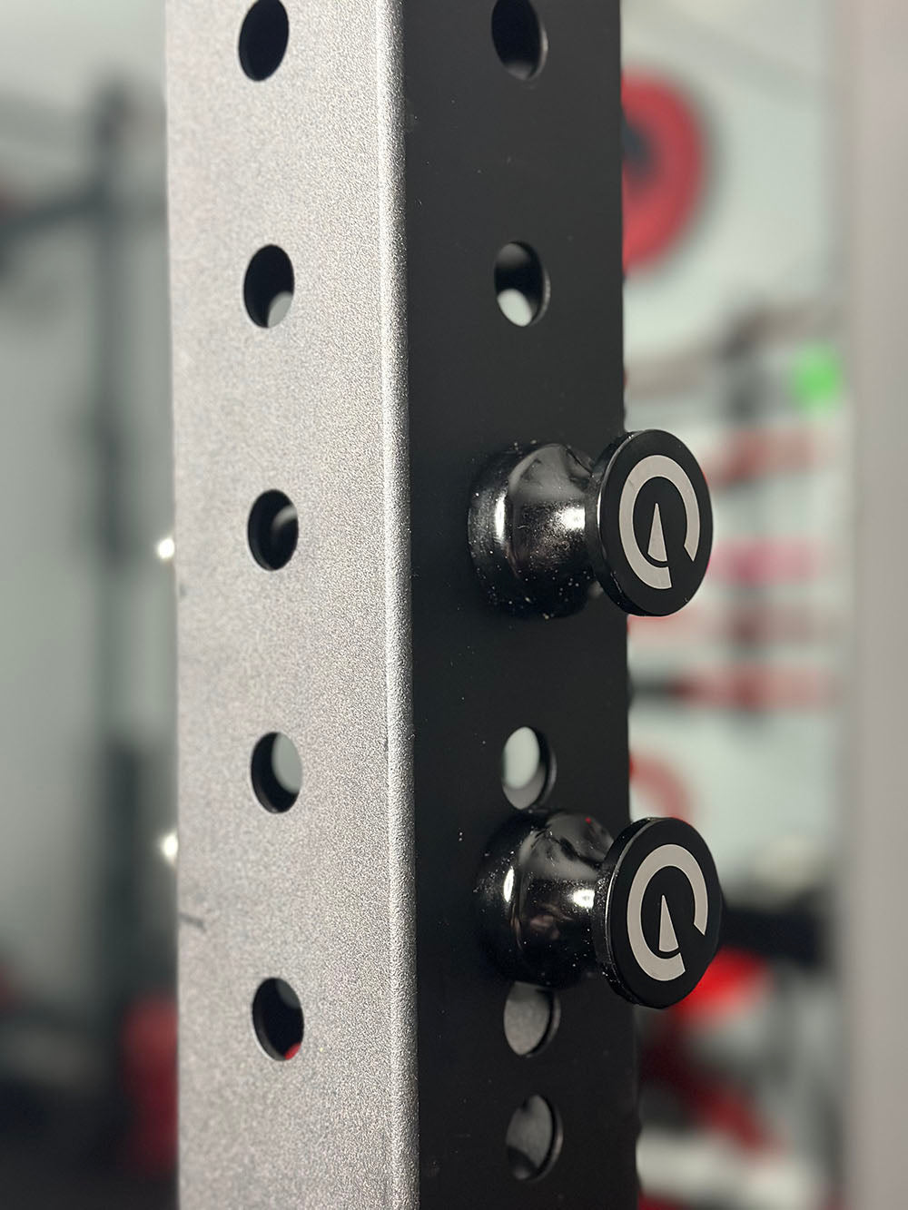 Custom Exponent Edge Magnetic pins fit all major brands of squat racks, power racks, and accessories, including Exponent Edge workout equipment. This image presents the Magnetic Edge Pins in black on a squat rack.
