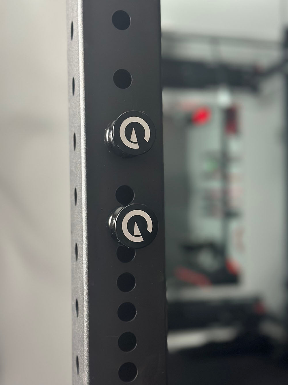 Custom Exponent Edge Magnetic pins fit all major brands of squat racks, power racks, and accessories, including Exponent Edge workout equipment. This image presents the Magnetic Edge Pins on a workout rack.