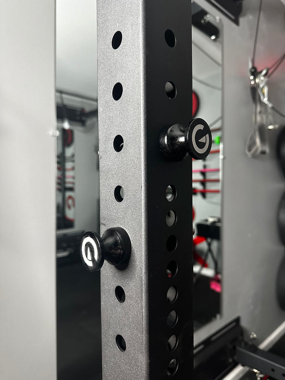 Custom Exponent Edge Magnetic pins fit all major brands of squat racks, power racks, and accessories, including Exponent Edge workout equipment. This image presents the Magnetic Edge Pins on a squat rack.