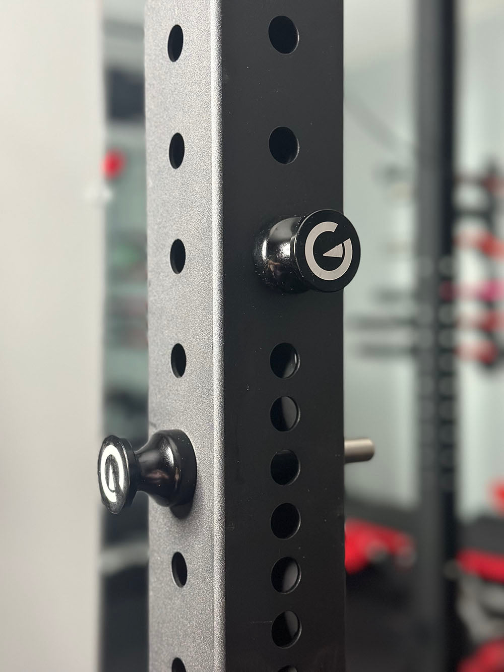 Custom Exponent Edge Magnetic pins fit all major brands of squat racks, power racks, and accessories, including Exponent Edge workout equipment. This image presents the Magnetic Edge Pins on a power rack.