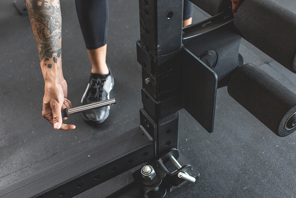 This Rack Mounted Glute Ham Developer is less bulky and lower priced than conventional GHDs. Perfect for glute workouts, ab workouts, and hamstring workouts. This image presents the Rack Mounted Glute Ham Developer being attached to a power rack.