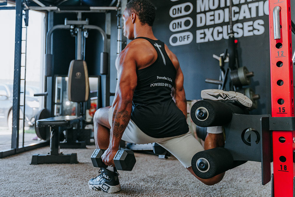 This Rack Mounted Glute Ham Developer is less bulky and lower priced than conventional GHDs. Perfect for glute workouts, ab workouts, and hamstring workouts. This image presents the Rack Mounted Glute Ham Developer being used by a man doing a leg workout in a home gym.