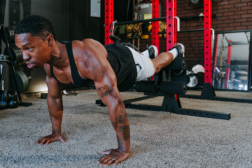 This Rack Mounted Glute Ham Developer is less bulky and lower priced than conventional GHDs. Perfect for glute workouts, ab workouts, and hamstring workouts. This image presents the Rack Mounted Glute Ham Developer being used for a chest workout.