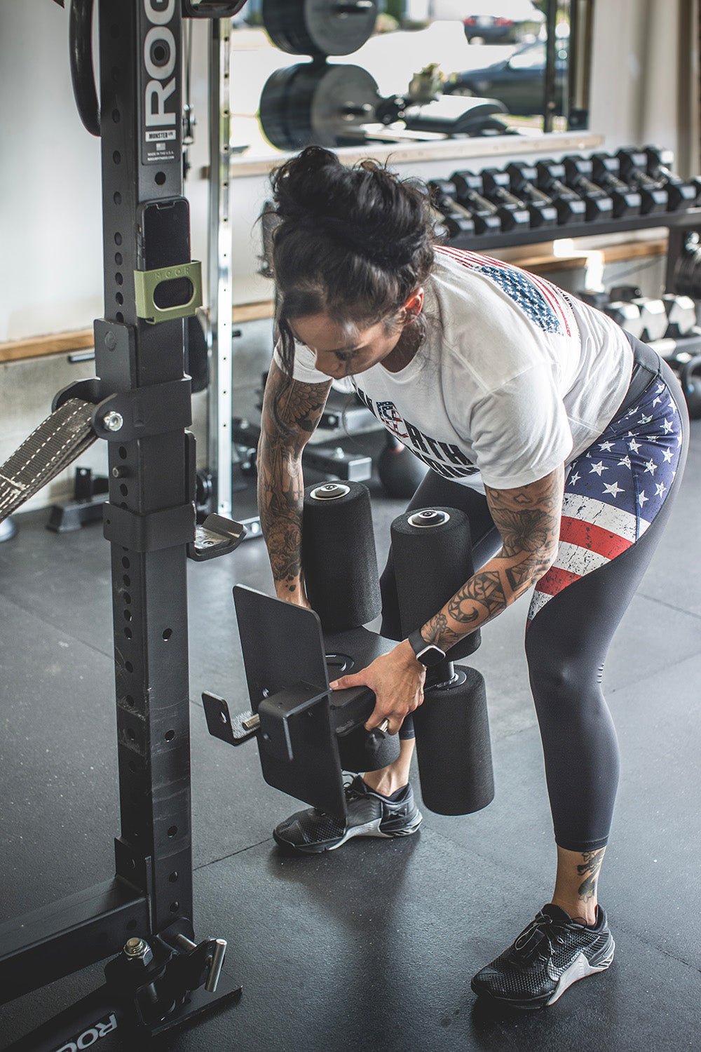 This Rack Mounted Glute Ham Developer is less bulky and lower priced than conventional GHDs. Perfect for glute workouts, ab workouts, and hamstring workouts. This image presents the Rack Mounted Glute Ham Developer being attached to a workout rack in a home gym.